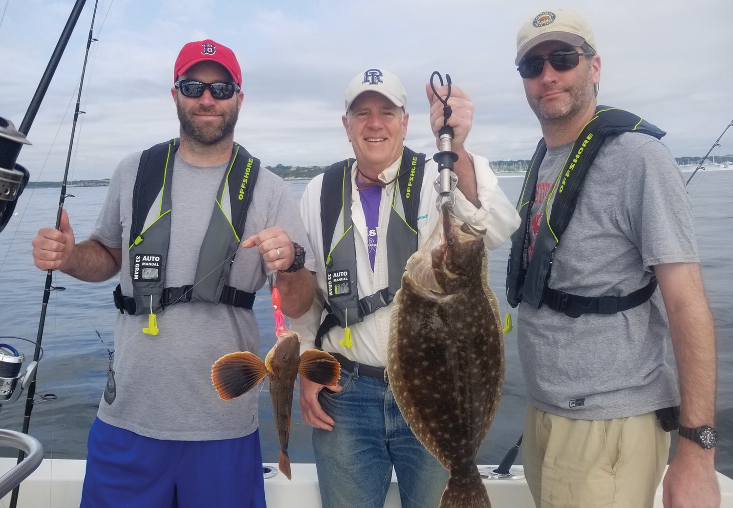 MIXED BAG FOR DINNER:  Jim Malachowski of Cranston (center) with sons Jimmy and Mitchell caught fluke to 25-inch and black sea bass to 19 inches. Scup, sea robins and sand sharks were in the mix too.                                               